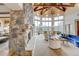 Light-filled living room with stone fireplace, vaulted ceiling, and mountain view at 2521 Juniper Ct, Golden, CO 80401