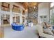 Large living room with stone fireplace and vaulted wood beam ceiling at 2521 Juniper Ct, Golden, CO 80401