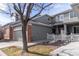 Beautiful gray home featuring an attached garage and picket fence at 12613 Knox Pt, Broomfield, CO 80020