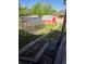 Backyard boasts a charming greenhouse, red shed, and ample green space at 465 Salem St, Aurora, CO 80011
