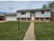 Classic two-story home featuring light siding, brick accents, and a two car garage at 465 Salem St, Aurora, CO 80011
