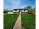Traditional two-story home with light siding and a well-maintained lawn at 465 Salem St, Aurora, CO 80011