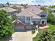 Beautiful aerial view of home with tile roof, two-car garage, patio area, landscaping, and neighborhood at 6254 S Riviera Ct, Aurora, CO 80016