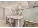 Basement bar area with granite counters, stylish seating, and custom cabinets for storage at 6254 S Riviera Ct, Aurora, CO 80016