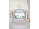 A bright bathroom featuring a large soaking tub surrounded by windows, white cabinetry, and elegant fixtures at 6254 S Riviera Ct, Aurora, CO 80016