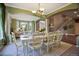 Spacious dining area featuring a large table, decorative columns, and access to living areas at 6254 S Riviera Ct, Aurora, CO 80016