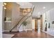 Spacious foyer with hardwood flooring, winding staircase, high ceilings, and neutral paint at 6254 S Riviera Ct, Aurora, CO 80016
