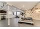 Finished basement gym area with workout equipment and a climbing wall for exercise at 6254 S Riviera Ct, Aurora, CO 80016
