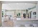 Open concept kitchen with island, bar seating, breakfast nook, and stainless steel appliances at 6254 S Riviera Ct, Aurora, CO 80016