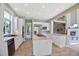 Bright kitchen with an island, stainless steel appliances, and wood tile flooring at 6254 S Riviera Ct, Aurora, CO 80016