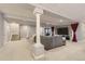 Spacious basement living area with plush seating and a large television for relaxation and entertainment at 6254 S Riviera Ct, Aurora, CO 80016