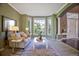 Cozy living room featuring bay window, neutral paint, plush carpet, and decorative accents at 6254 S Riviera Ct, Aurora, CO 80016