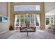 Bright living room with high ceilings, large windows, and neutral decor at 6254 S Riviera Ct, Aurora, CO 80016