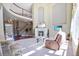 Bright living room with soaring ceilings, large windows, fireplace, and comfortable seating area at 6254 S Riviera Ct, Aurora, CO 80016