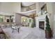 Open-concept living area with fireplace, hardwood floors, and view of kitchen and dining room at 6254 S Riviera Ct, Aurora, CO 80016