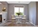 Cozy sitting area adjacent to a fireplace in a room featuring elegant furnishings and natural lighting at 6254 S Riviera Ct, Aurora, CO 80016