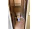 Cozy bathroom features a standard toilet, shower, tile flooring, and built-in shelving at 14096 E Radcliff Cir, Aurora, CO 80015