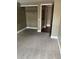 Neutral carpeted bedroom featuring closet and access to another room at 14096 E Radcliff Cir, Aurora, CO 80015