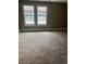 Spacious bedroom with carpet flooring and two windows that let in lots of natural light at 14096 E Radcliff Cir, Aurora, CO 80015