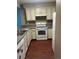 Traditional kitchen with white cabinetry, laminate countertops, and a stainless steel sink at 14096 E Radcliff Cir, Aurora, CO 80015