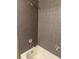 Shower with gray tile and white bathtub at 14096 E Radcliff Cir, Aurora, CO 80015