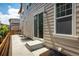 Exterior view of home's backyard with small patio area at 1125 Anker Dr, Erie, CO 80516
