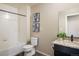 Well-lit bathroom featuring granite vanity and shower over tub at 1125 Anker Dr, Erie, CO 80516