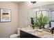 Well-lit bathroom features a double vanity, granite countertop, modern fixtures, and a tiled glass shower at 1125 Anker Dr, Erie, CO 80516