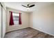 Comfortable bedroom featuring stylish floors, window and ceiling fan at 1125 Anker Dr, Erie, CO 80516