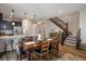 Bright dining area features hardwood floors, stairs to the upper level, and an adjacent kitchen with a breakfast bar at 1125 Anker Dr, Erie, CO 80516