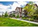 Neighborhood street view with well-maintained lawns and beautiful landscaping at 1125 Anker Dr, Erie, CO 80516