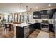 Modern kitchen featuring stainless appliances, island, and dining area at 1125 Anker Dr, Erie, CO 80516