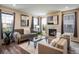 Comfortable living room with fireplace, hardwood floors, and lots of natural light at 1125 Anker Dr, Erie, CO 80516