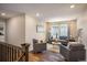 Open-concept living room offers modern seating, a plush rug, and large windows providing natural light at 1125 Anker Dr, Erie, CO 80516
