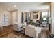 Spacious living room with hardwood floors, neutral colors, and lots of seating at 1125 Anker Dr, Erie, CO 80516