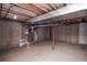 Unfinished basement with water heater and concrete walls at 2217 S Nome Ct, Aurora, CO 80014