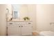 Bathroom featuring white cabinetry, neutral walls, and vanity sink at 2217 S Nome Ct, Aurora, CO 80014