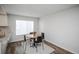 Dining area featuring a table and chairs set, with a window providing natural light at 2217 S Nome Ct, Aurora, CO 80014