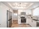 Modern kitchen with stainless steel appliances, including a refrigerator, microwave, and oven at 2217 S Nome Ct, Aurora, CO 80014