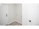 A functional laundry room with white walls, and tile flooring at 2217 S Nome Ct, Aurora, CO 80014