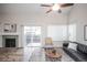 Cozy living room with fireplace, sliding door to backyard, and vaulted ceiling at 2217 S Nome Ct, Aurora, CO 80014