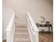 Carpeted stairway, and entry console table at 2217 S Nome Ct, Aurora, CO 80014