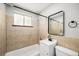 Bathroom featuring neutral tile, a vanity sink, bathtub and a mirror at 1150 Rosemary St, Denver, CO 80220