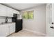 Bright kitchen featuring white cabinets, modern sink fixture and a window at 1150 Rosemary St, Denver, CO 80220