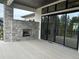 Outdoor patio with a stone fireplace and sliding glass doors creates a seamless indoor-outdoor living experience at 5841 Powell Rd, Parker, CO 80134