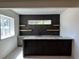 Stylish bar area with tiled backsplash, stone counter, and built-in sink adds charm at 5841 Powell Rd, Parker, CO 80134
