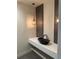 Modern bathroom with vessel sink on a sleek countertop and stylish pendant lighting at 5841 Powell Rd, Parker, CO 80134