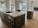 The stunning kitchen features an island with a sink, bar seating, and dark wood cabinets at 5841 Powell Rd, Parker, CO 80134