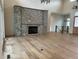 Grand living room showcases a stone fireplace, high ceilings, and an abundance of natural light at 5841 Powell Rd, Parker, CO 80134