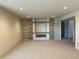 Cozy living room featuring a fireplace with stone accents and custom built-in shelving at 5841 Powell Rd, Parker, CO 80134